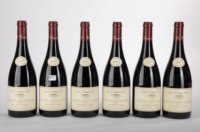 six bottles of red wine lined up in a row