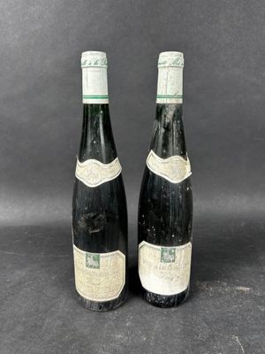 two bottles of wine sitting next to each other on a table