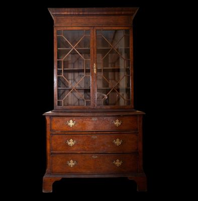 an antique wooden cabinet with glass doors and drawers