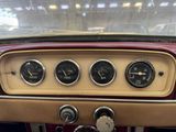 three gauges on the dashboard of a red car
