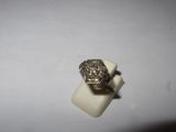 a close up of a silver ring on a white surface