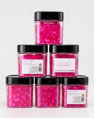 six jars of pink glitter with black lids and black lids