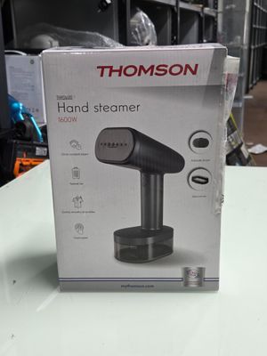 une boîte contenant un appareil à vapeur pour les mains, posée sur une table