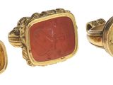 trois bagues en or et une bague sertie d'une pierre rouge