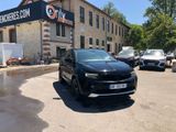 a black suv parked in front of a building
