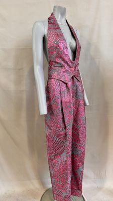 a mannequin wearing a pink and grey patterned suit on a white mannequin