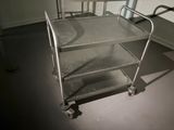 a metal cart that is sitting in the middle of a room