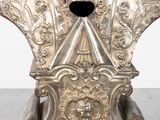 a silver statue of a man with a hat on his head