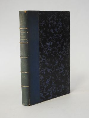 an old book sitting on top of a white table next to a white wall
