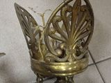 a small metal object on a tile floor with a bird on it