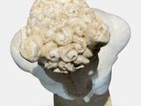 a statue of a head with a bunch of hair on it