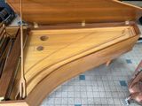 a piano that is sitting on the floor in the room