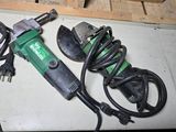a green and black electric tool on the floor
