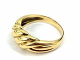 a close up of a gold ring on a white surface