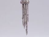 silver plated pendant with chain and tassels hanging from it ' s side