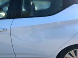 a dog sitting in the passenger seat of a white car
