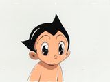 cellule d'animation représentant un jeune garçon aux cheveux noirs, assis sur une surface blanche