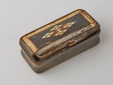 a small wooden box with a design on it