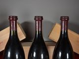three bottles of wine sitting on a table next to a wooden box