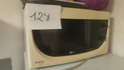 a microwave with a price tag on it sitting on a counter