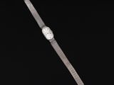 a close up of a wrist watch on a black background