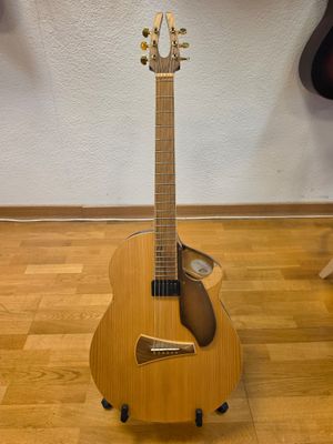 guitar on a stand in front of a wall with guitars in the background