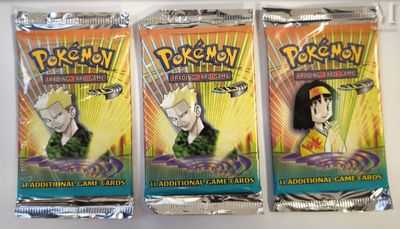 three packs of pokemon trading cards on a white surface