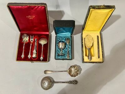 three silver spoons and two silver spoons in a box