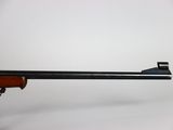 a close up of a rifle on a white background with a gun in the foreground