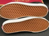vans off the wall slip on sneakers in a box on a table