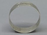 sterling silver ring with textured edges and a thin band