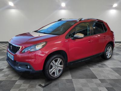a red car parked in a garage with a checkered floor