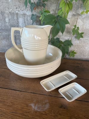 a white cup and saucer sitting on a wooden table