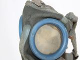 a man in a gas mask holding a magnifying glass