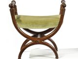 a small wooden bench with a green cushion on it