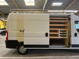 a white van parked in a parking lot with its doors open