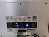 an image of a digital clock on the side of a refrigerator