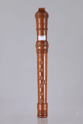 the flute is made of wood and has a flute stand