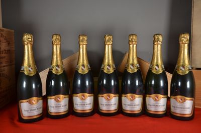 six bottles of champagne lined up in a row on a table