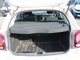 a white car with its trunk open in a parking lot