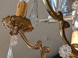 a close up of a chandelier with a mirror in the background