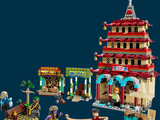 a lego town with a building and people on the street