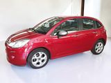a picture of a red car parked in a garage
