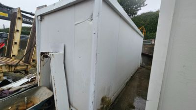 an image of a dumpster being moved into a dumpster
