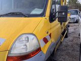 a yellow truck that is parked next to a white truck