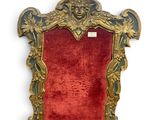 a red chair with a gold frame and a red seat