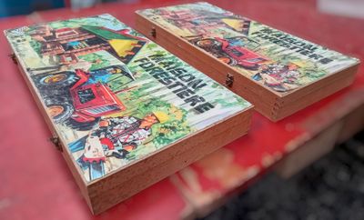 two books that are sitting on a red table