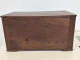 a small wooden box with holes in it on a table