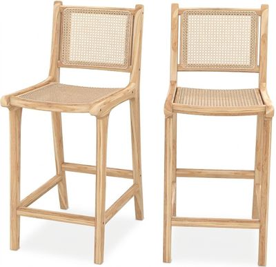two wooden barstools with wicker backrests against a white background