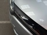 a close up of the front of a silver car